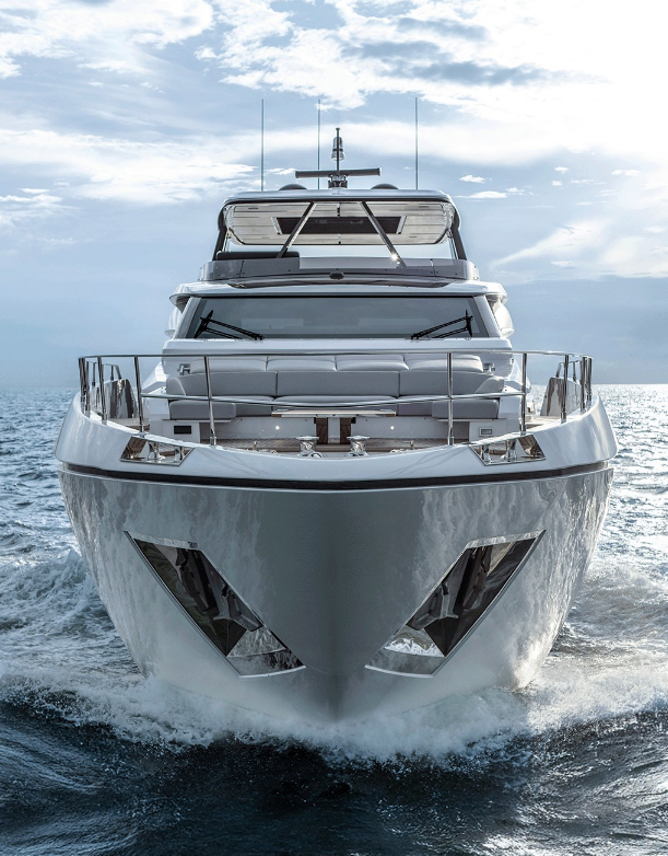 Luxury yacht bow cutting through blue water