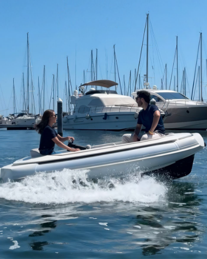 Couple cruising a marina in a tender